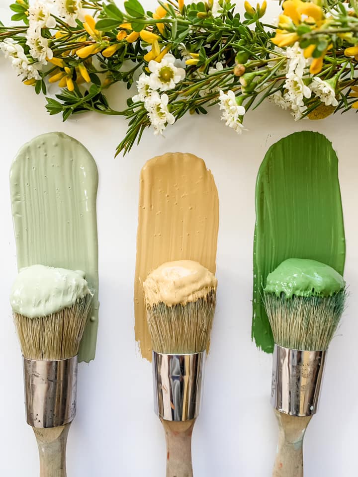 3 paint brushes painting sage, blush and forest green Mudpaint clay paint swaths.