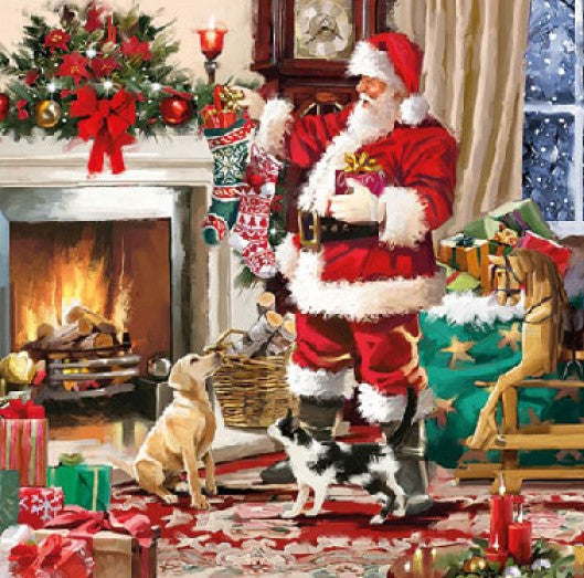 Santa in red next to a fireplace with green bag of toys filling hanging stocking  Decoupage Napkins