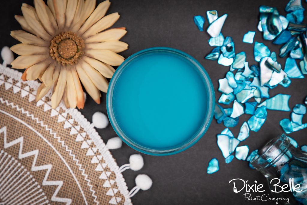 Jar of Dixie Belle chalk mineral paint in the color of Peacock Blue