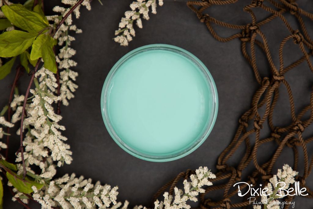 Jar of Dixie Belle chalk mineral paint in the color of the gulf green
