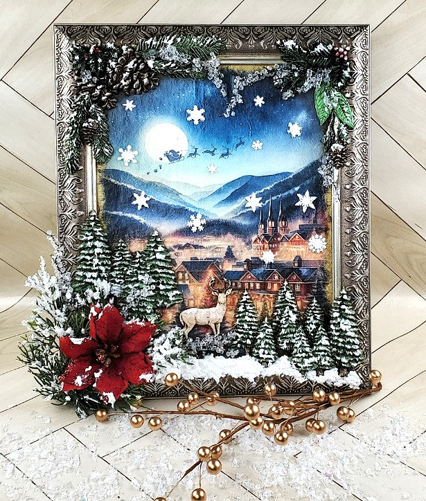 mixed media christmas project with beutifulf rice from Decoupage Creatives of a christmas town in winter and a shadow of Santa and sleigh flying over the town.