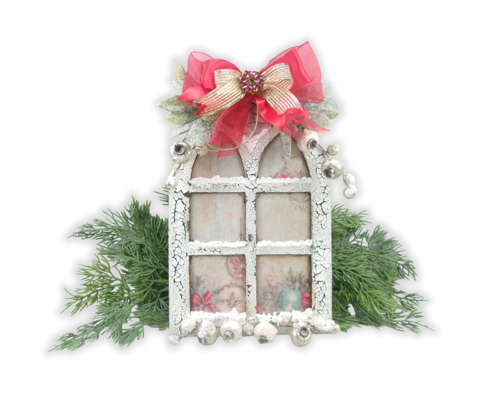 Handmade Christmas chapel window decoration with crackled white frame, frosted snow accents, greenery, silver bells, and a red and gold ribbon bow.