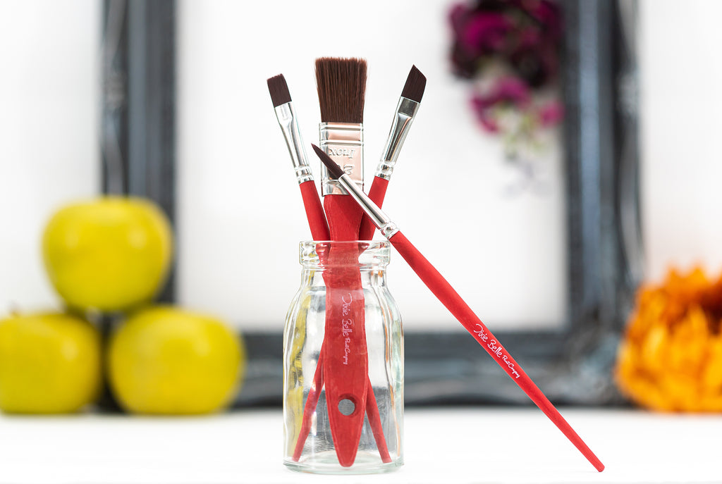 Red paint brushes in a jar. Dixie Belle paint supplies.