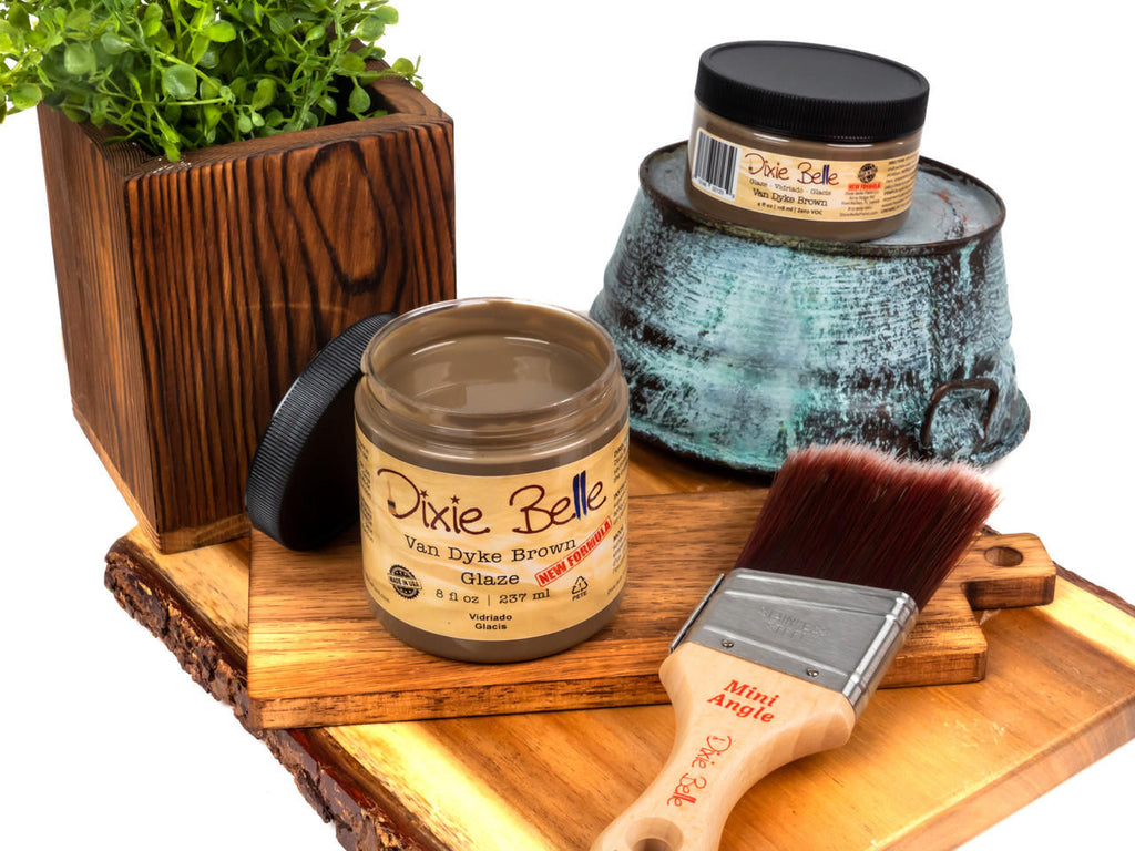 Dixie Belle Glaze in Van Dyke Brown color. Photo of jar and paint brush on wood pieces.