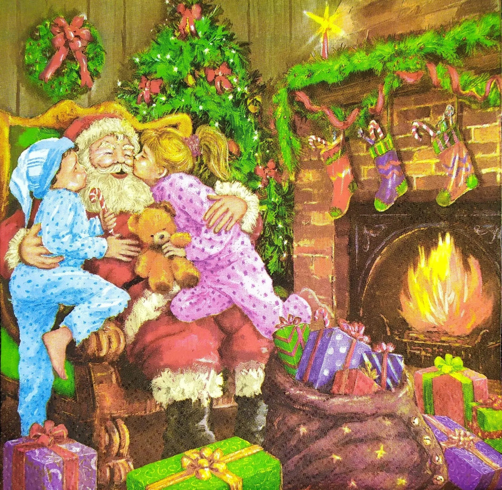 Santa sitting in a chair by a fireplace being kissed by 2 children on the cheeks with bag full fo presents Decoupage Napkins