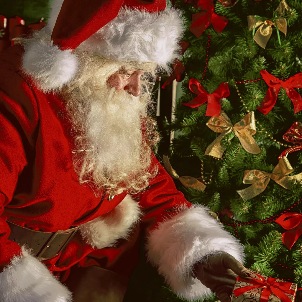 Santa putting a present under a green christmas tree Decoupage Napkins
