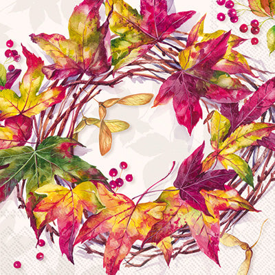 Brightly colored burgundy & orange fall colored wreath on paper napkin for decoupage.