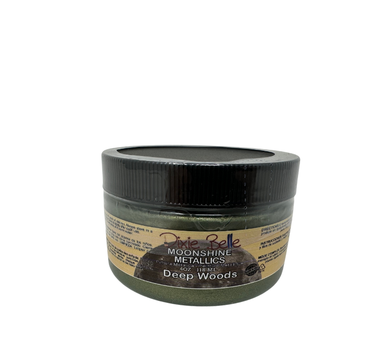 A jar of Dixie Belle Moonshine Metallics paint in the color Deep woods, a green shade.