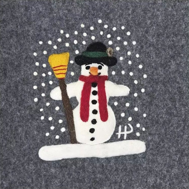 Felt snowman decoration with a broom and red scarf on a gray background