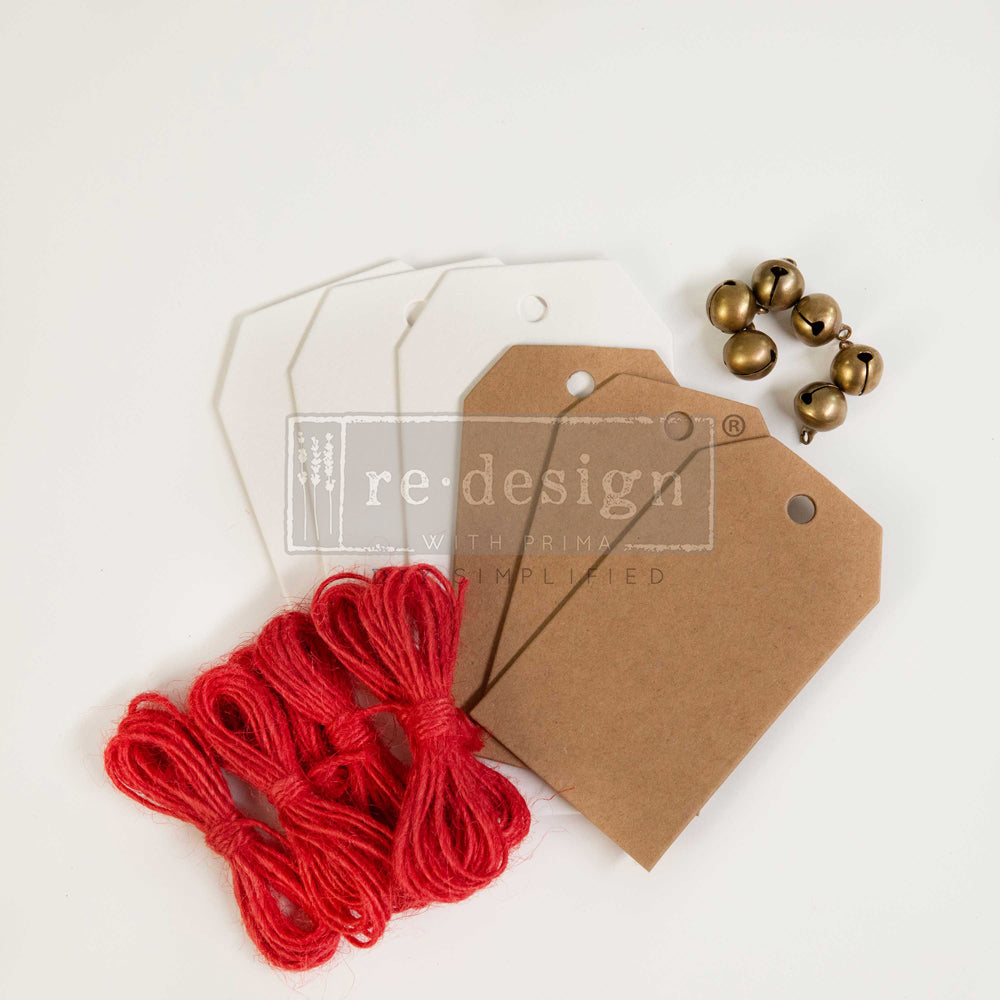 Redesign Christmas chipboard. This set includes six tags (3 tags sized 2.3″x4.75″ + 3 tags sized 2”x3.5″) + six gold bells + red twine.