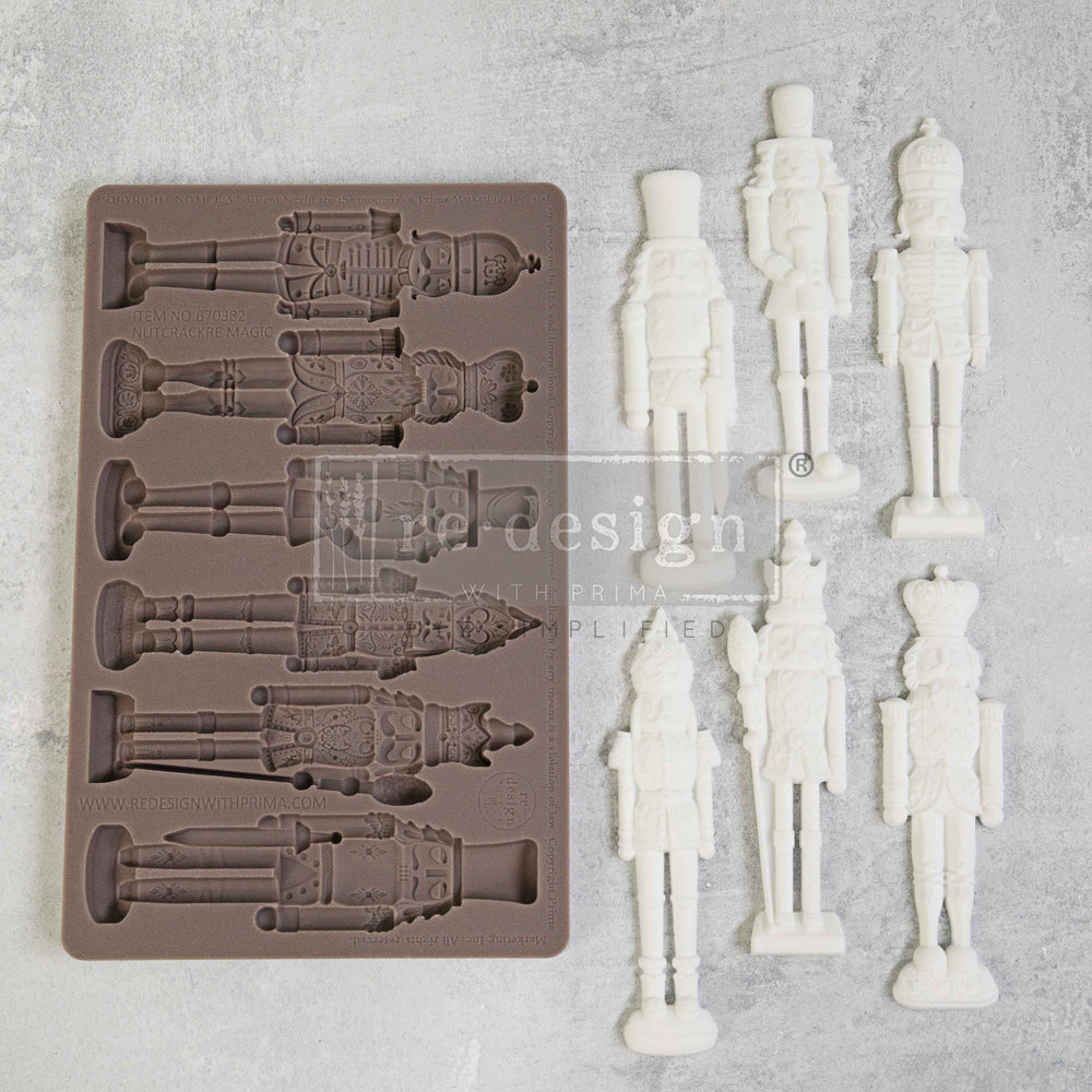 Brown silicone mold of nutcrackers with moldings of white clay Nutcracker Magic