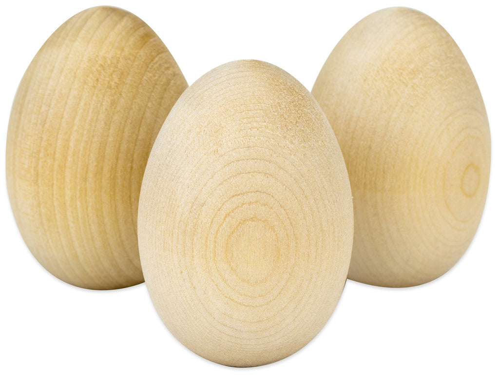 Three wooden eggs on a white background