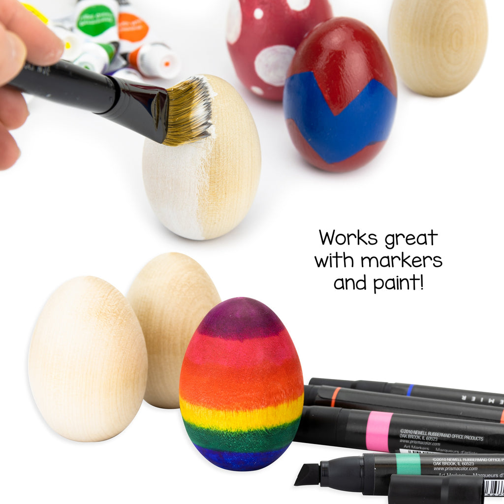 Colorful wooden eggs being painted with markers and paint on a white background
