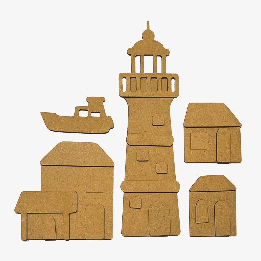 Set of MDF wood cutouts shaped like a lighthouse, boat, and houses on a white background