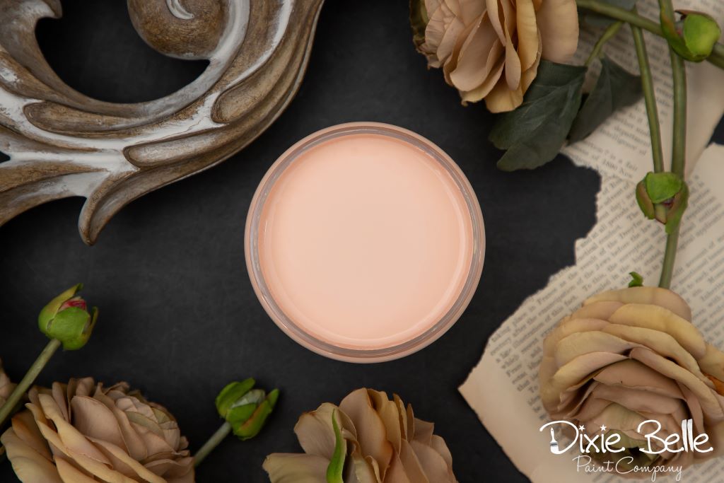 Jar of Dixie Belle chalk mineral paint in the color of  apricot pink