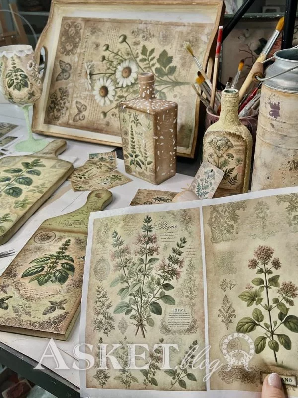 Decorative items with botanical designs on a table, including bottles and trays.