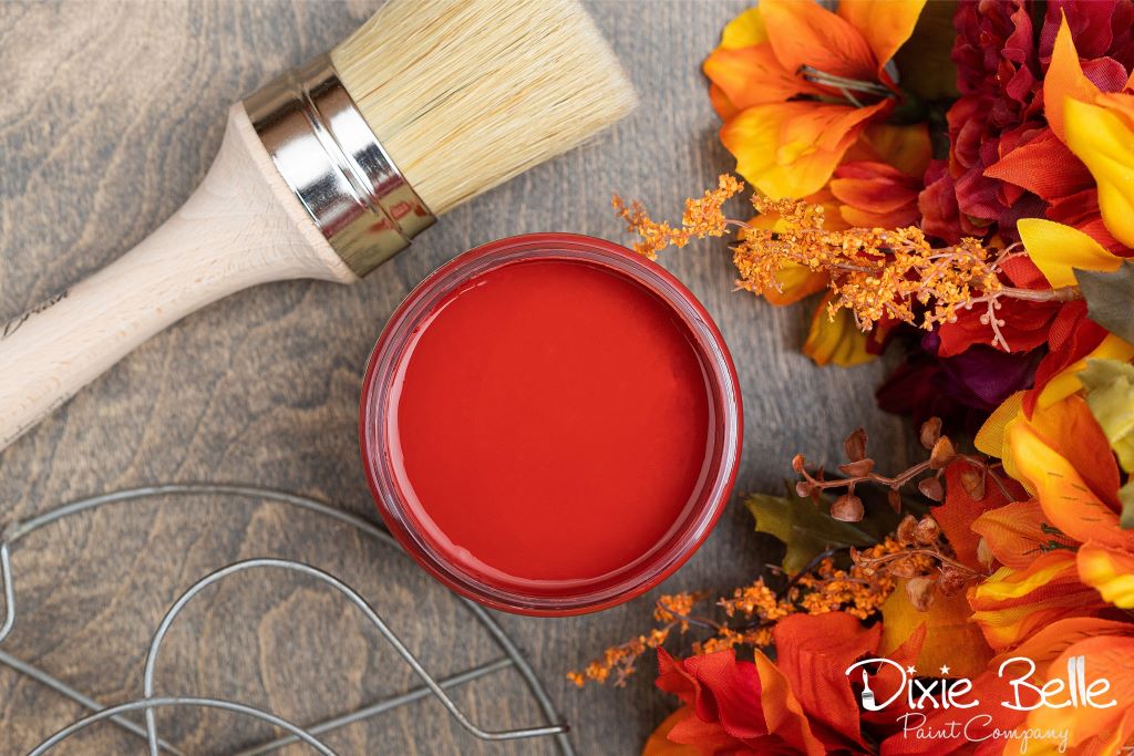 Jar of Dixie Belle chalk mineral paint in the color of Barn red