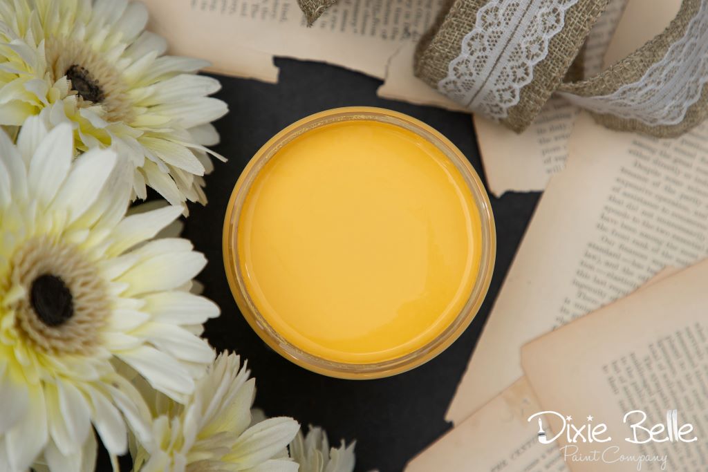 Jar of Dixie Belle chalk mineral paint in the color of Daisy Yellow