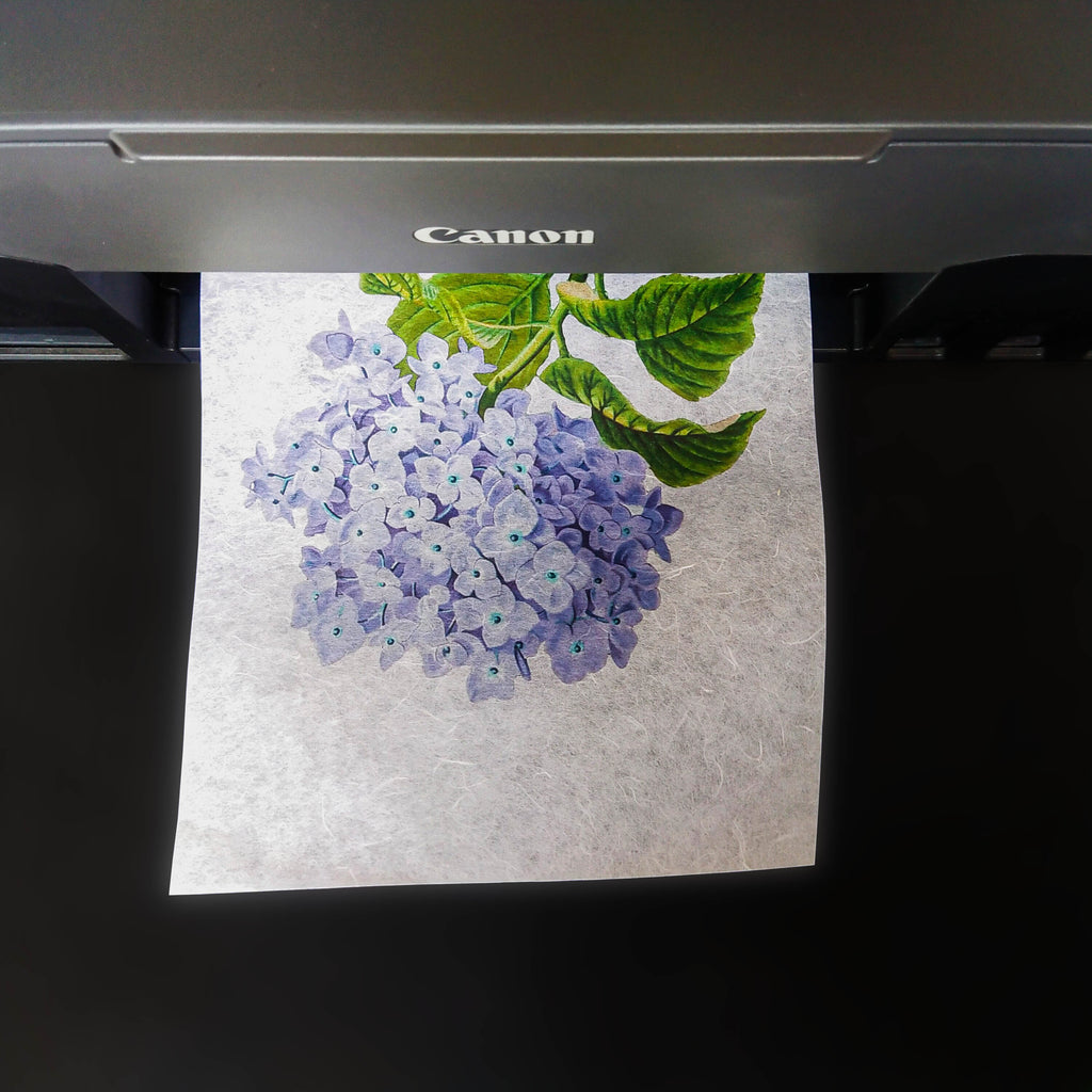 picture of white printable decoupage rice paper from KOZO with blue hydrangea being printed.