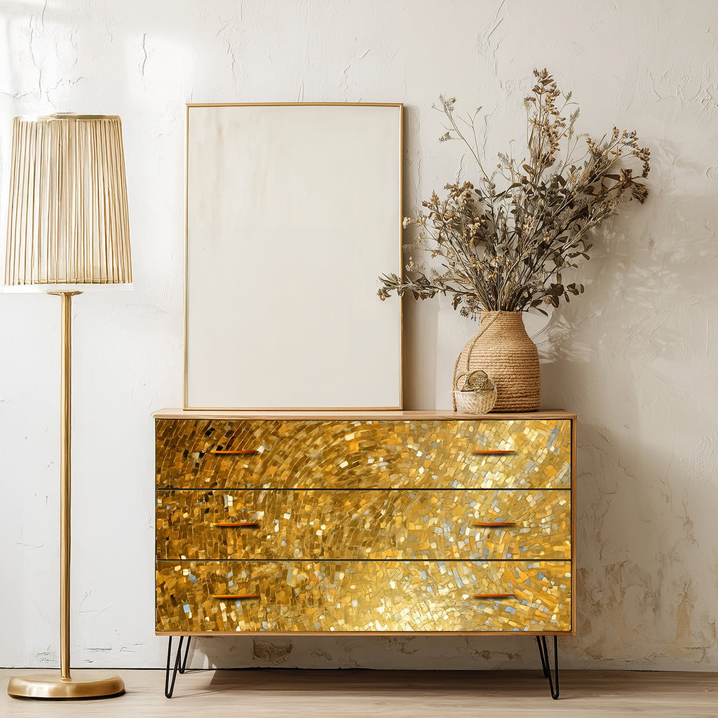 Gold metallic dresser with a lamp and decorative vase in a room setting