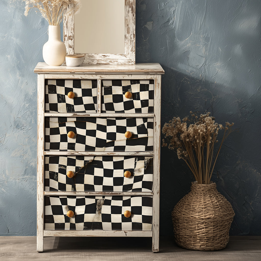 Wooden dresser with checkered pattern and wooden vase against a textured wall