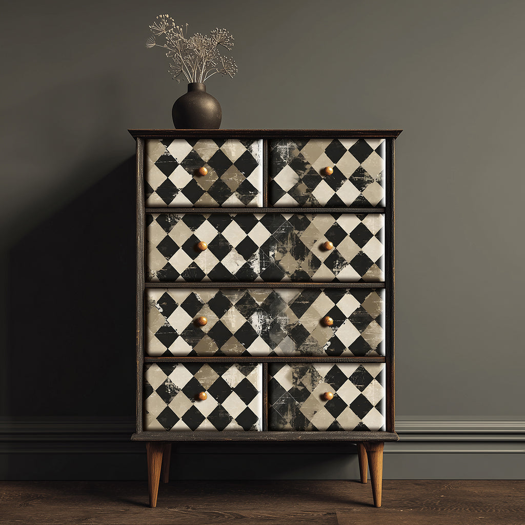 Wooden dresser with checkered patterned drawers against a dark wall.