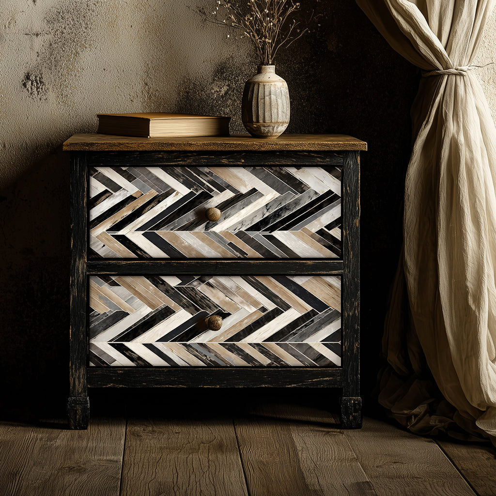 Wooden nightstand with a chevron pattern in a dimly lit room.