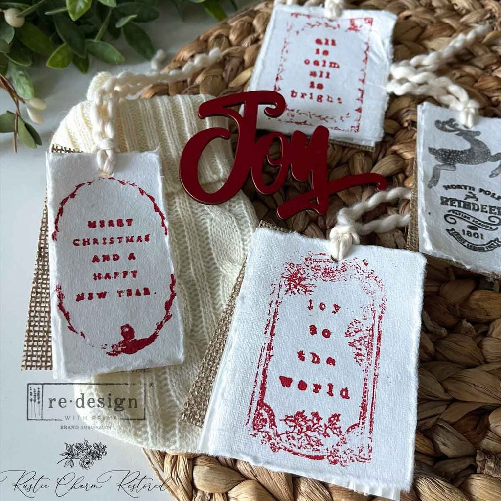 Holiday clear stamp set with snowflakes, trees, mittens, candy cane, bells and Christmas salutations from ReDesign with Prima