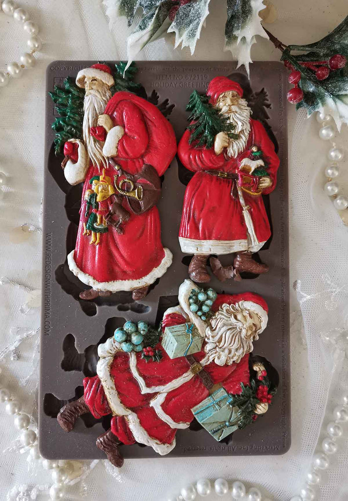 Redesign with Prima Holiday Greeting mold with 3 figures; Santas carrying greenery and presents