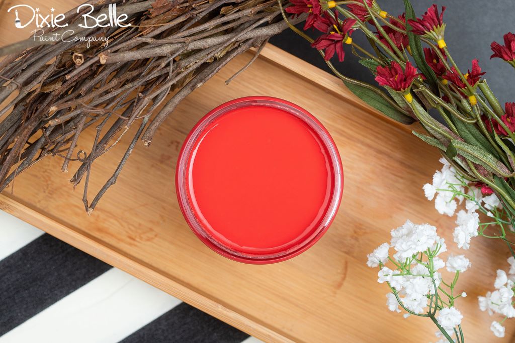 Jar of Dixie Belle chalk mineral paint in the color of Honky Tonk Red