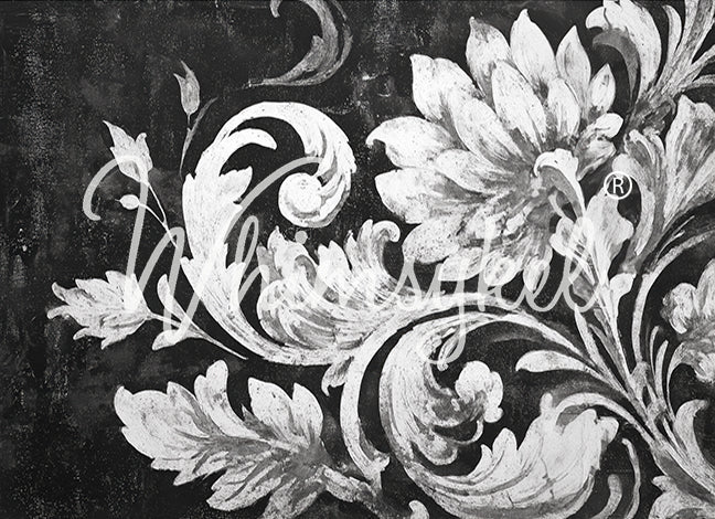 Decorative floral and leaf pattern in white on a black background
