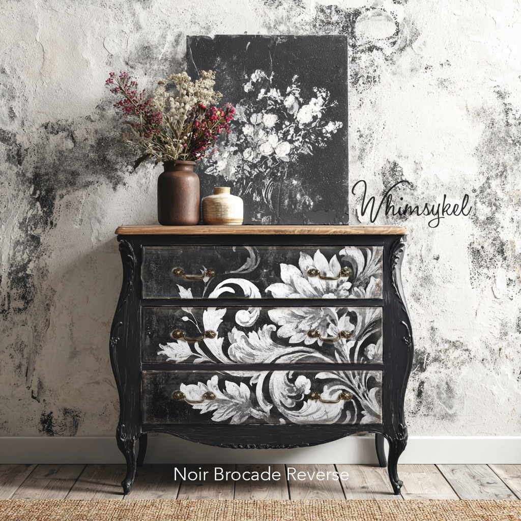 Decorative black chest of drawers with floral design against a textured wall, featuring the brand 'Whimsykel'.