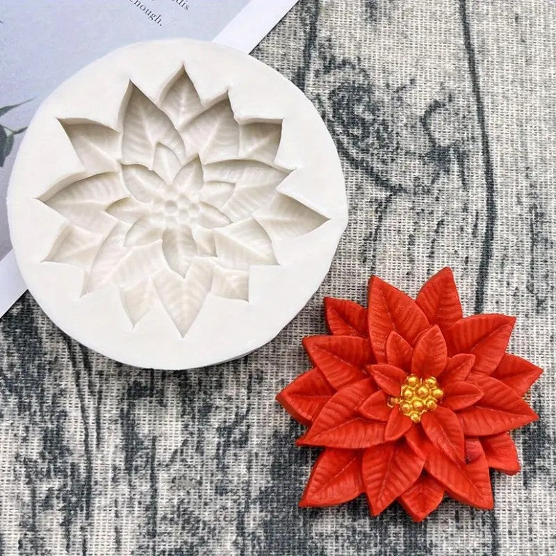 Silicone mold shaped like a flower with a red flower decoration on a textured surface