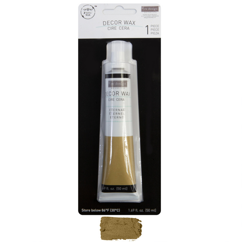 One tube of Decor Wax - Eternal, by Redesign with Prima. Gold color wax in a white tube.