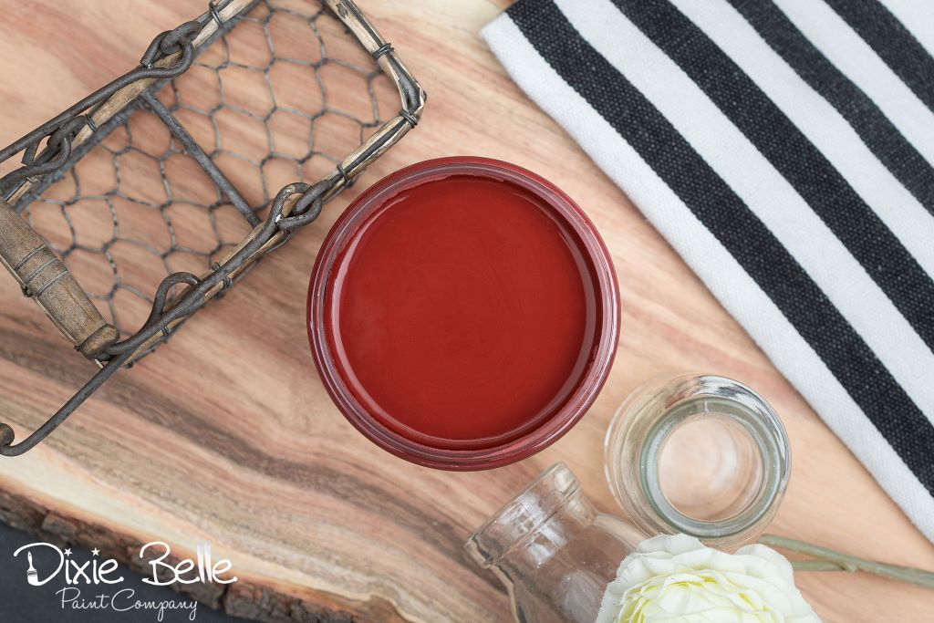 Jar of Dixie Belle chalk mineral paint in the color of Rustic Red