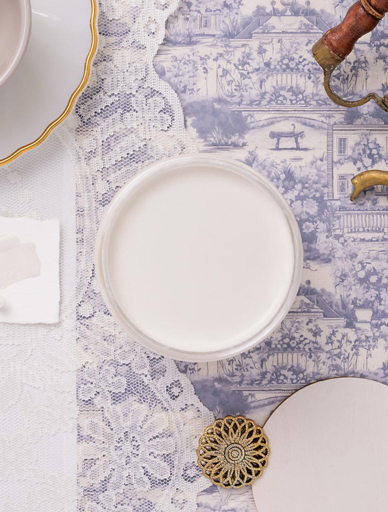 White ceramic plate on a decorative tablecloth with intricate patterns