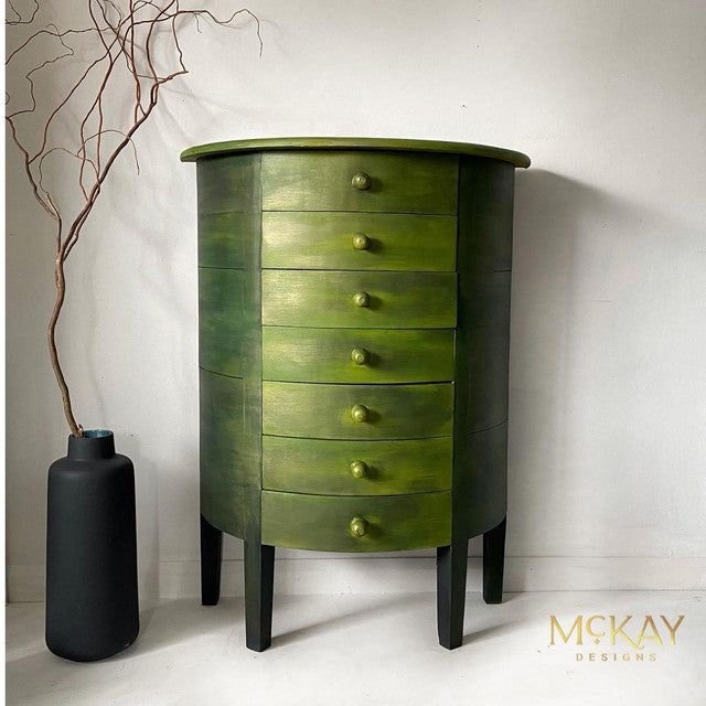 Green cabinet coated in Dixie Belle Glaze in the color of Copper Bronze.