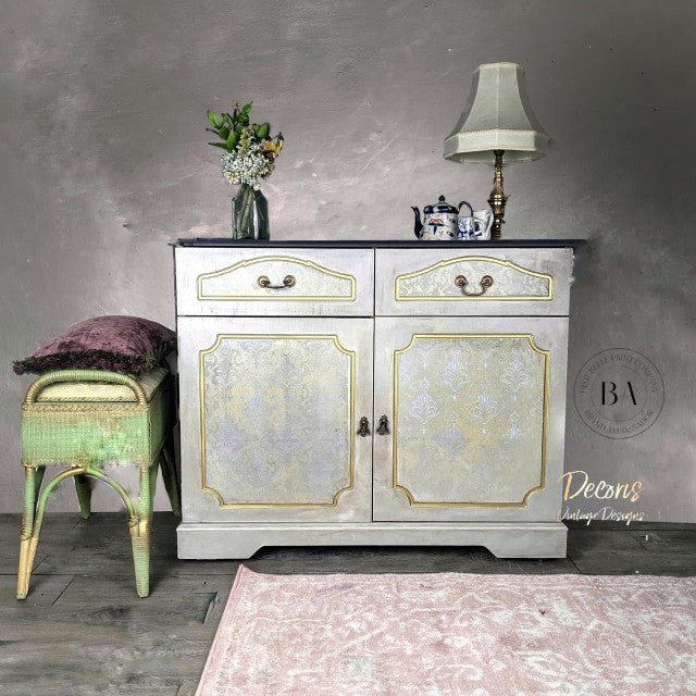 Grey cabinet coated in Dixie Belle Glaze in the color of Gold Shimmer