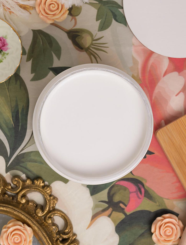 Round white object on a floral-patterned surface with decorative elements