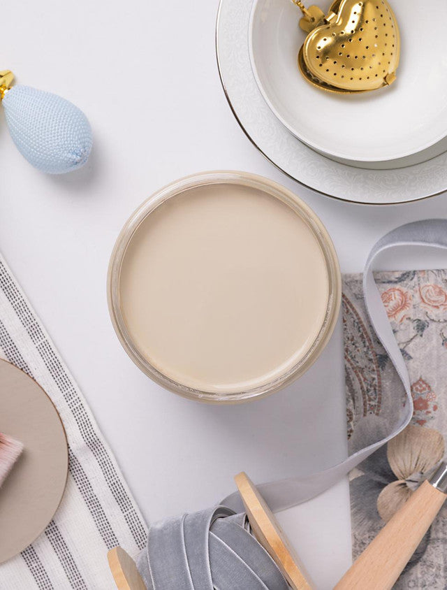 Collection of ceramic plates and kitchen items on a white surface