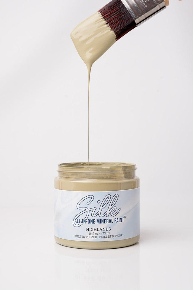 Jar of Silk All-in-One Mineral Paint with a brush applying paint