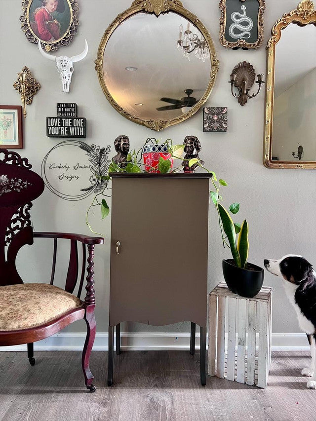 Vintage-style room with ornate mirrors, a wooden cabinet, and decorative items.
