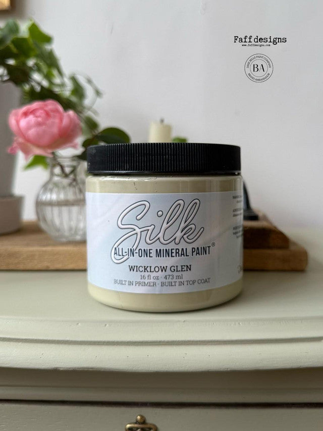 Container of Silk All-in-One Mineral Paint on a surface with a blurred background